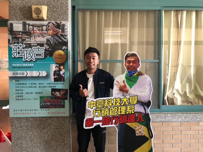 第一屆行銷達人-莊政吉與牆面招牌及人型立牌合影