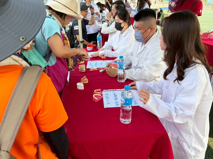 牙技系學生教導民眾貝氏刷牙法圖片